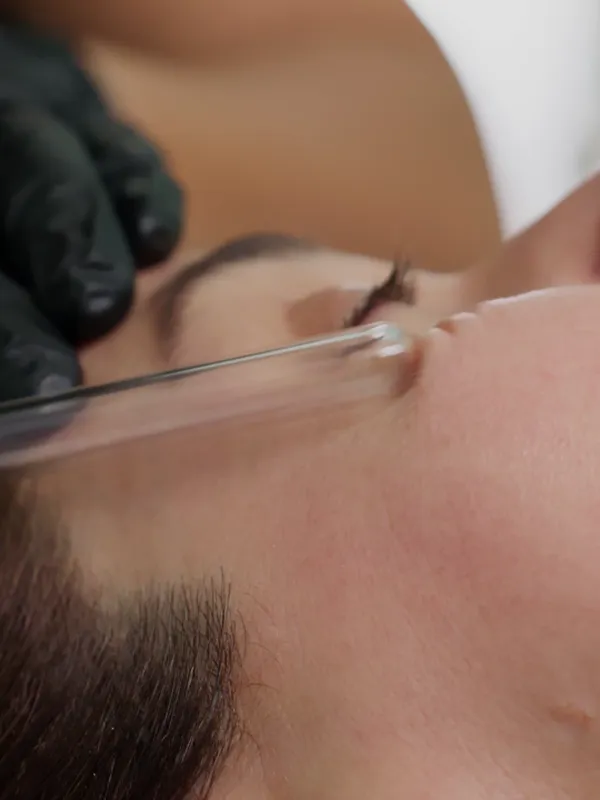 A skin treatment device on a client's face