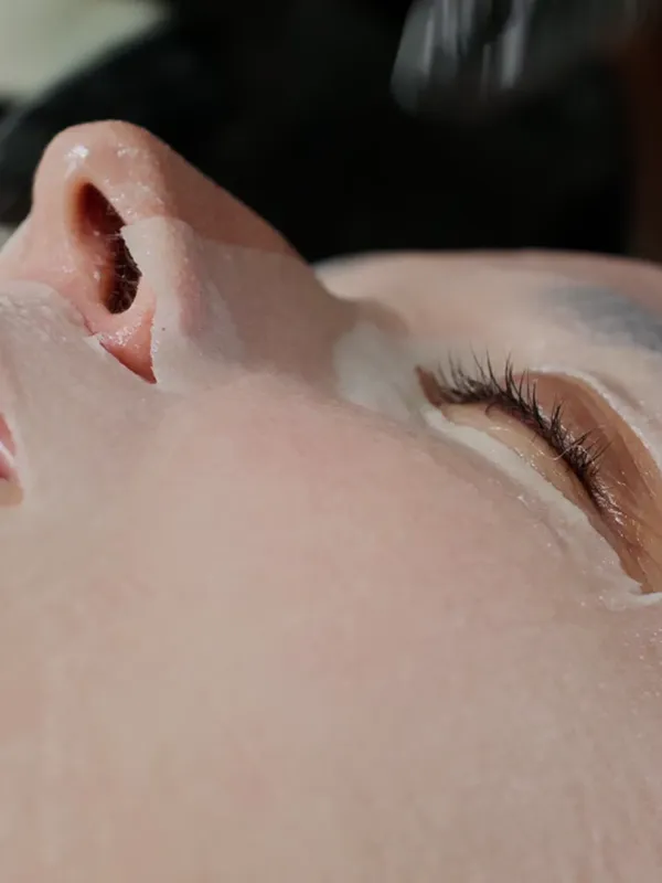 A client's smooth skin during a facial treatment