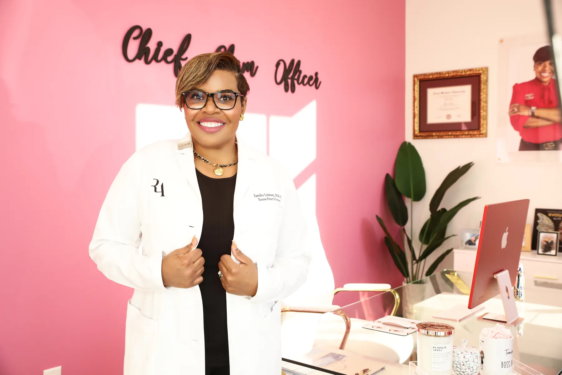 Tamika Lindsey in her pink office at Exclusively Radiant MedSpa